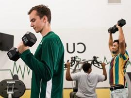 Students working out in CU Active fitness center.